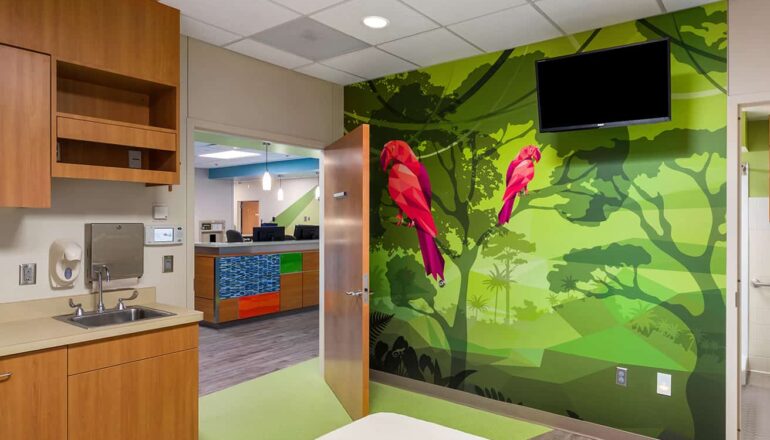 Footwall and view to the nurses station from a patient room featuring a parrot wall mural.